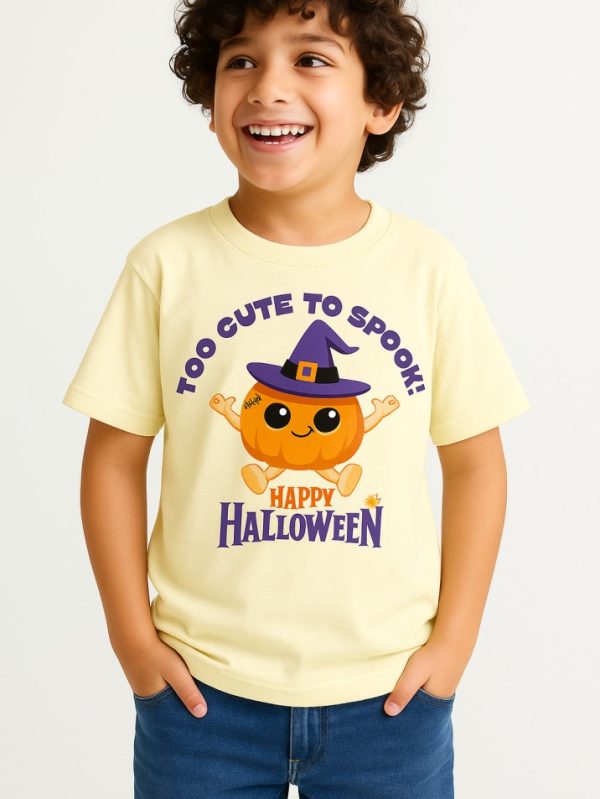 Cream kids’ t-shirt with cute pumpkin wearing a witch hat and “Too Cute To Spook” Halloween print — festive outfit for toddlers and kids.